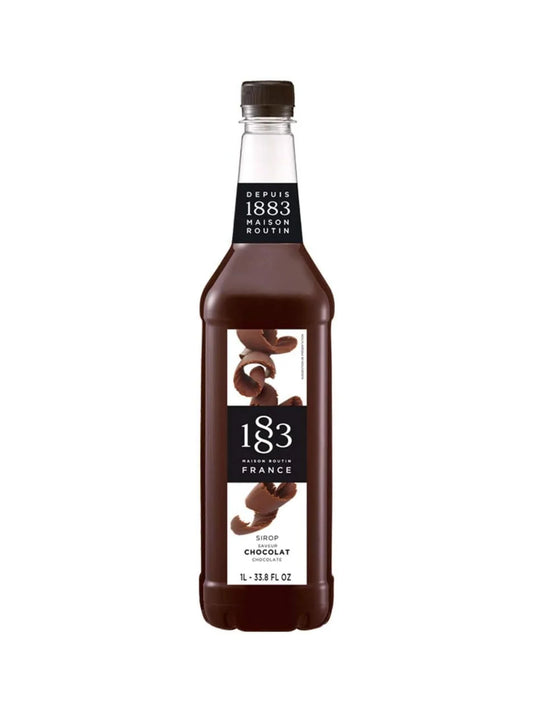 A bottle of 183 Chocolate Syrup on a plain white background. The dark brown liquid inside the clear bottle is visible, along with a black cap and a label featuring chocolate pieces and the brand name '183'.